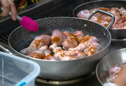 Pans with chicken meat stand on the stove, frying chicken, cooking, real picture in the kitchen