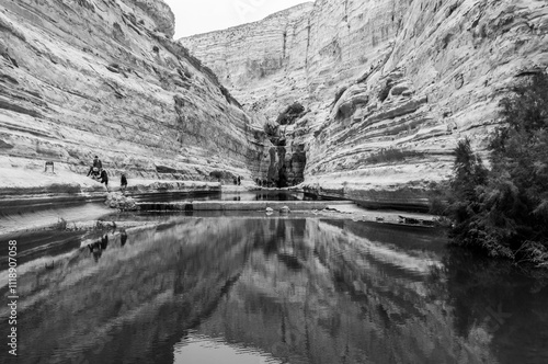 A black and white photo of a river with a waterfall