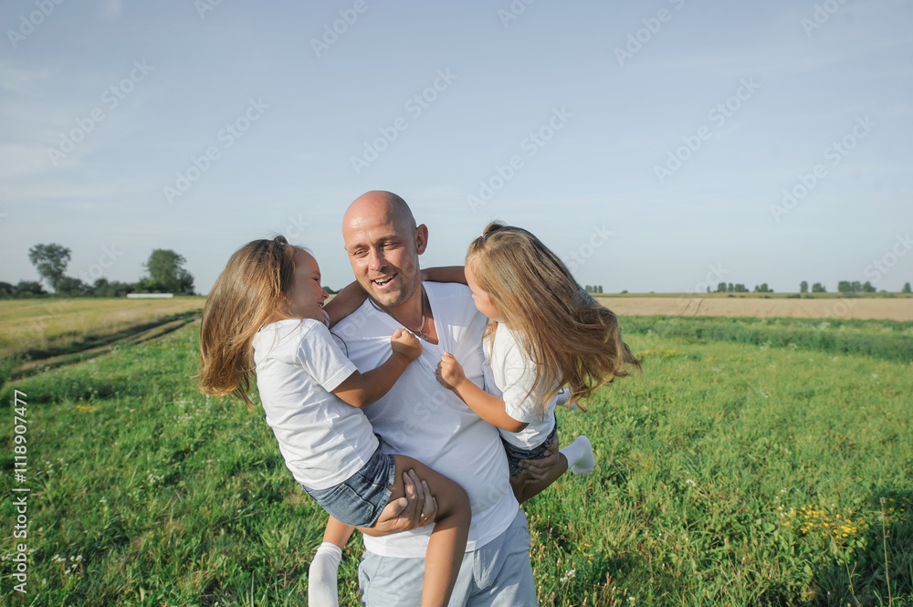 Dad has two children in his arms.Happy kids dad Dad has two children in his arms.Happy kids dad