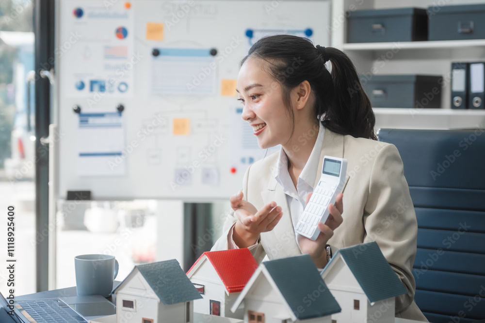 Asian professional woman sits at desk in modern office, reviewing real estate documents and financial plans. confidently, assists with property investments, loans, and contracts, business ventures. Asian professional woman sits at desk in modern office, reviewing real estate documents and financial plans. confidently, assists with property investments, loans, and contracts, business ventures.