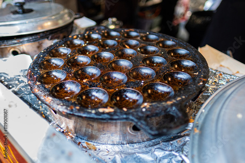 Close-Up of Traditional Cast Iron Aebleskiver Pan Used for Cooking Popular Danish Dessert in a Home Kitchen Setting