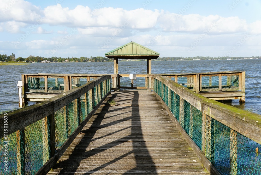 A weathered wooden pier, extending into the water near Lake Hartridge Nature Park, Winter Haven, Florida, U.S A weathered wooden pier, extending into the water near Lake Hartridge Nature Park, Winter Haven, Florida, U.S