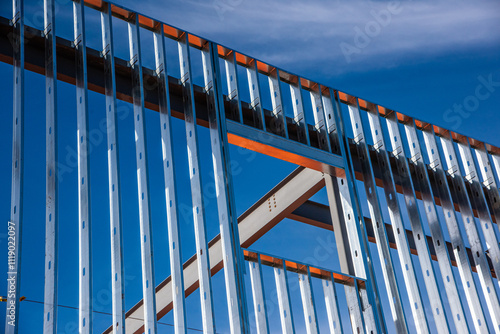 Metal studs along exterior wall of steel framed office building under construction.