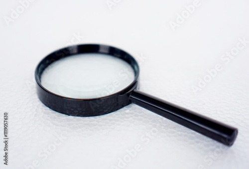 magnifying glass with 75mm diameter with 3x magnification, black plastic handle isolated on white background photo