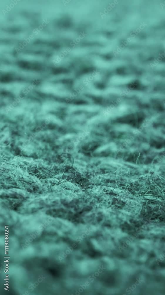 Extreme detail view of sheep wool cloth texture in macro dolly shot. Flowing animal fiber material for handcraft knitting. Textile abstract background. Winter fashion clothing industry concept.