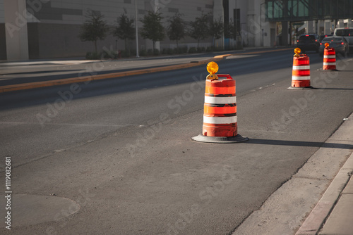 Orange construction barrels used for traffic control and roadwork zones on an urban street in Las Vegas, USA. These plots are iconic of North American road system