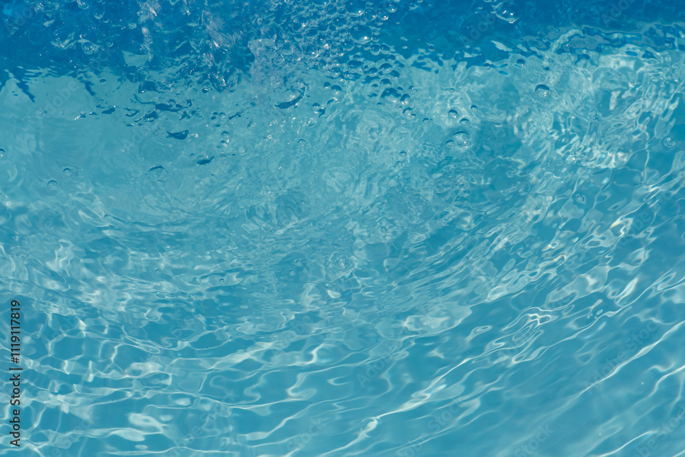 Blue water with ripples on the surface. Defocus blurred transparent blue colored clear calm water surface texture with splashes and bubbles. Water waves with shining pattern texture background. Blue water with ripples on the surface. Defocus blurred transparent blue colored clear calm water surface texture with splashes and bubbles. Water waves with shining pattern texture background.