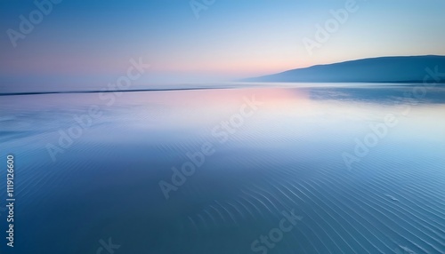 Serene coastal landscape at dawn with gentle waves.