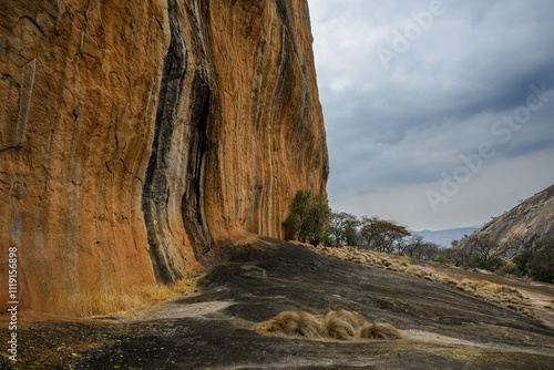 A granite cliff rises up from the batholith, Ngomakurira, Zimbabwe photo