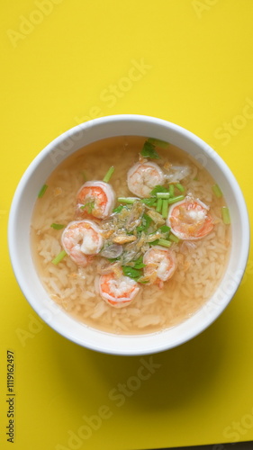 Wallpaper Mural rice soup with shrimp in white bowl on yellow background Torontodigital.ca