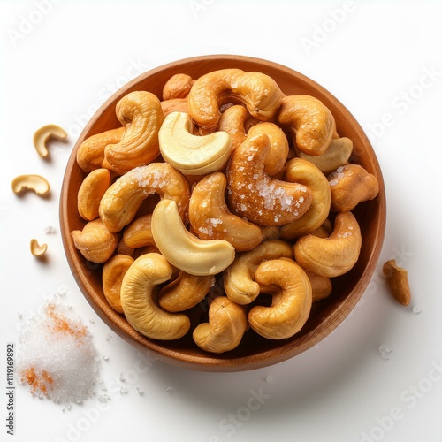 Golden-brown salted cashew nuts with fine salt granules on a white background, showcasing their natural texture and fresh, savory appeal