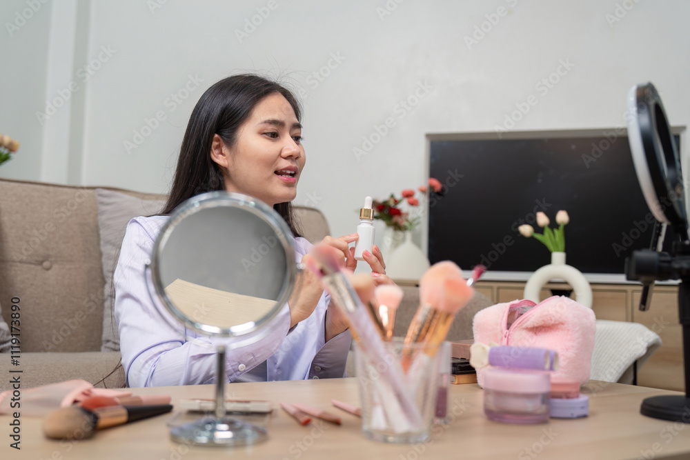 Asian beauty influencer applying makeup during video tutorial Asian beauty influencer applying makeup during video tutorial