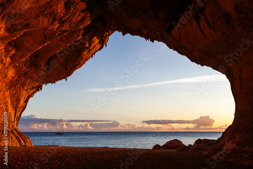 Cala Luna. Sardinia. Mediterranean sea view from the cave. Sail boat at sunnrise. Italy. photo