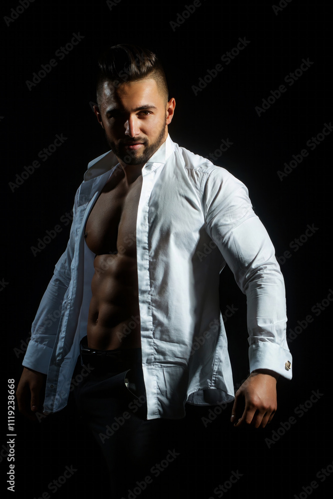 Sexy male model with hot naked body in white shirt. A sexy man in an unbuttoned white shirt on black studio. Handsome muscular man with naked torso and shirt. Sexy Guy with with open shirt. Sexy male model with hot naked body in white shirt. A sexy man in an unbuttoned white shirt on black studio. Handsome muscular man with naked torso and shirt. Sexy Guy with with open shirt.