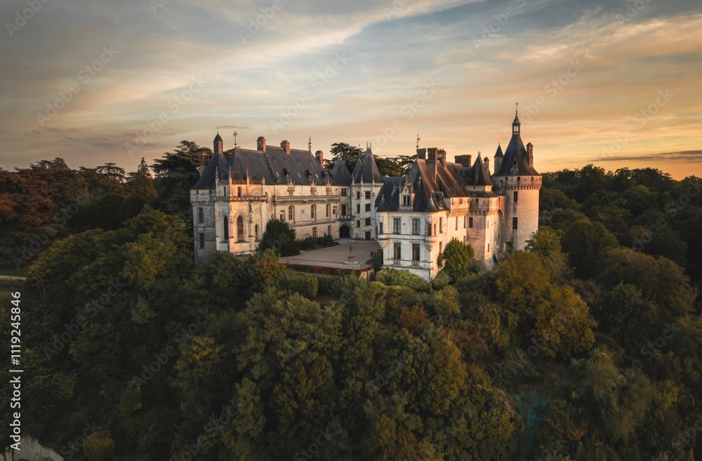 Majestic ancient castle perched on a hillside at sunset with lush greenery surrounding its grand facade Majestic ancient castle perched on a hillside at sunset with lush greenery surrounding its grand facade