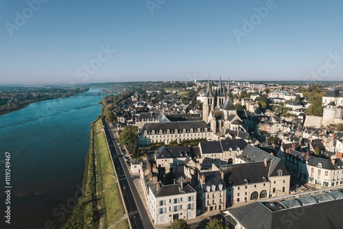 Wallpaper Mural Breathtaking view over the charming riverside town with historical architecture and serene waters under a clear blue sky Torontodigital.ca