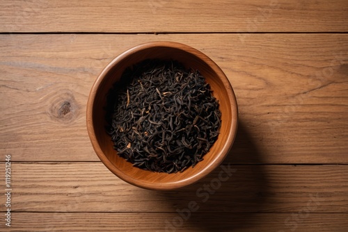 there is a bowl of tea on a wooden table