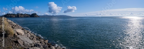 The distant lighthouse can be seen in a panorama from the north jetty at Cape Disappointment State Park in Ilwaco, Washington, USA