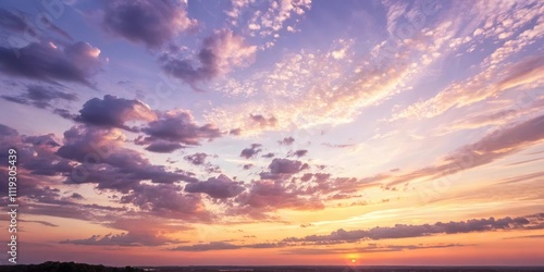 A breathtaking panorama of a sunset sky, filled with vibrant hues of purple, orange, and pink, showcasing the beauty of nature's artistry.