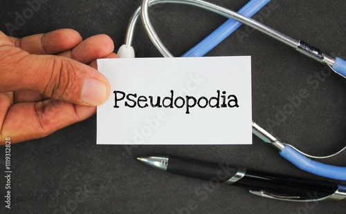 pen, stethoscope and paper with the word pseudopodia. a temporary protrusion of the surface of an amoeboid cell for movement and feeding. photo