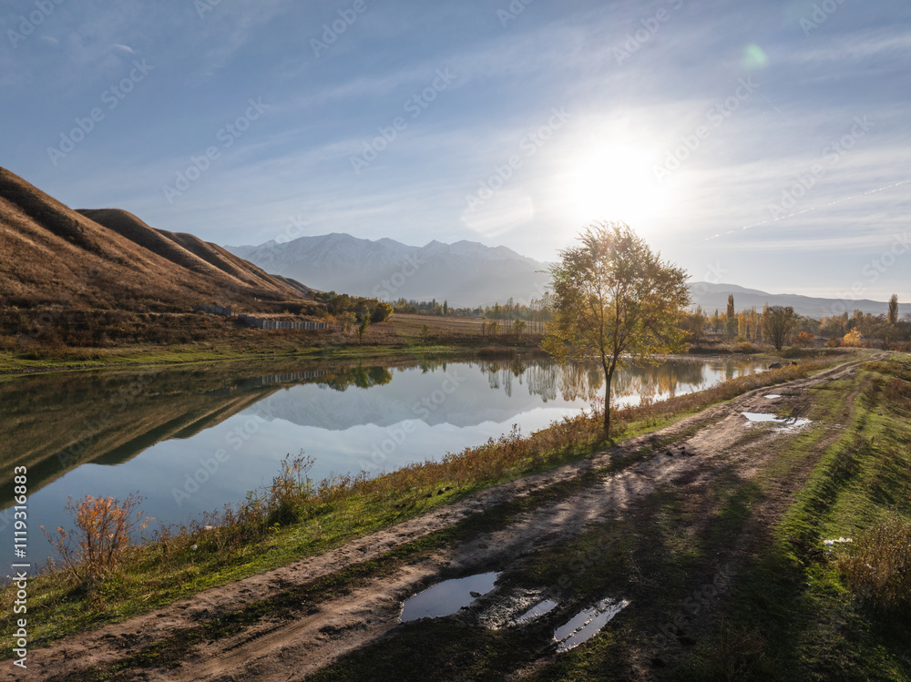 Drone view of landscape of a lake near the mountain at evening. Vivid natural scenery photo. Drone view of landscape of a lake near the mountain at evening. Vivid natural scenery photo.