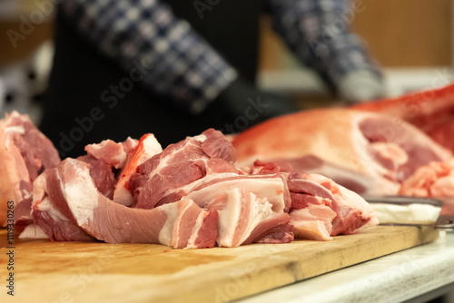 Canvas Print Freshly cut pork slices on a wooden table during butchering