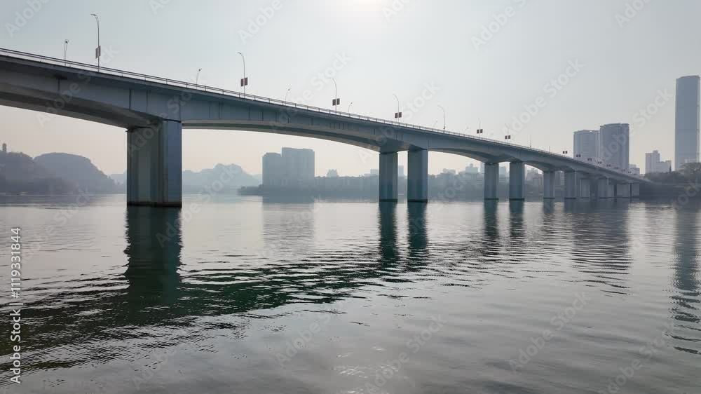 The Wenchang Bridge spans the Liujiang River in Liuzhou, China, connecting the city's central districts with the towering skyscrapers of the skyline on the horizon. The Wenchang Bridge spans the Liujiang River in Liuzhou, China, connecting the city's central districts with the towering skyscrapers of the skyline on the horizon.