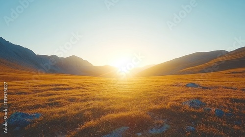 Golden hour sunset over vast mountain valley.