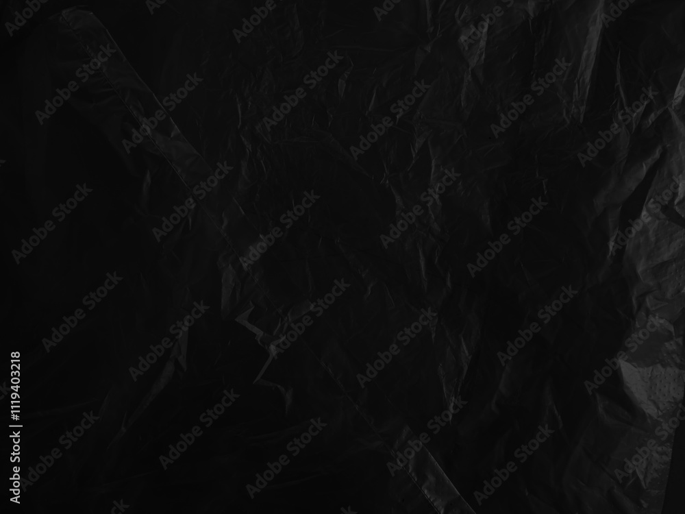 Fototapeta premium Black background plastic wrinkle bag film glossy crumpled overlay package rough wrap material pack reflection texture floor packaging retail grain pollution trash polyethylene, halloween backdrop.
