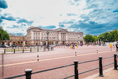 Tourists Visiting Iconic Buckingham Palace on a Cloudy Day Capturing the Historic Architecture and Vibrant Atmosphere of London
