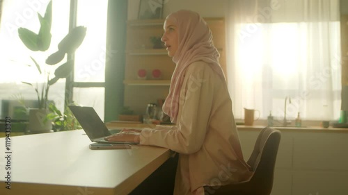 Time lapse video on muslim business woman wearing hijab working on laptop on desk table feel happy smiling at home. Feel tired. Sunlight. Camera moving around. 360 degrees