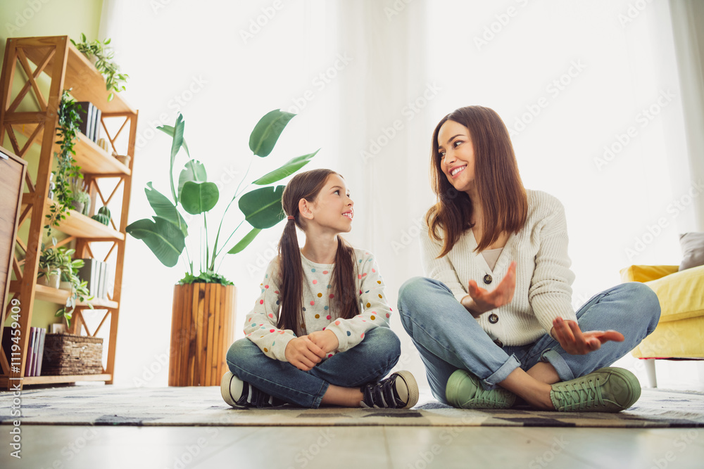Happy young mother bonding with daughter in cozy living room enjoying a beautiful spring day indoors Happy young mother bonding with daughter in cozy living room enjoying a beautiful spring day indoors