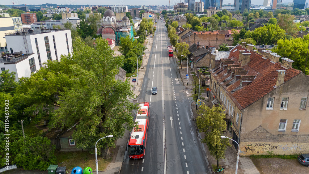 Naklejka premium Aerial View of City Street with Buses and Old Buildings