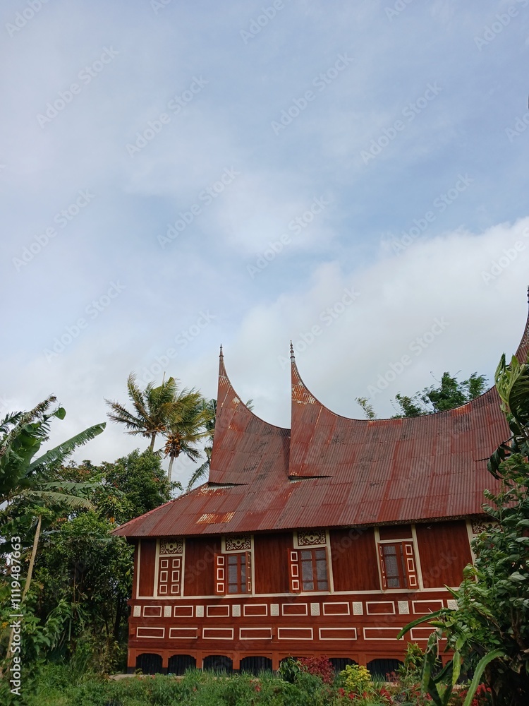 Fototapeta premium Big House or Rumah Gadang Around Green Rice Field