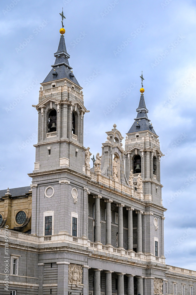 Obraz premium Facade of the Almudena Cathedral against an overcast sky, Madrid, Spain