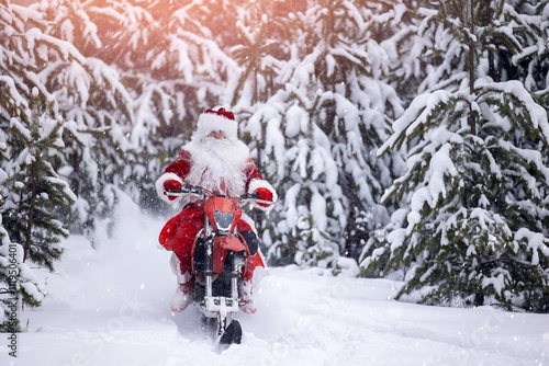 Concept delivery gift for Christmas holiday. Santa Claus in red cloth riding on snow bike, motorcycle with ski background snow forest photo