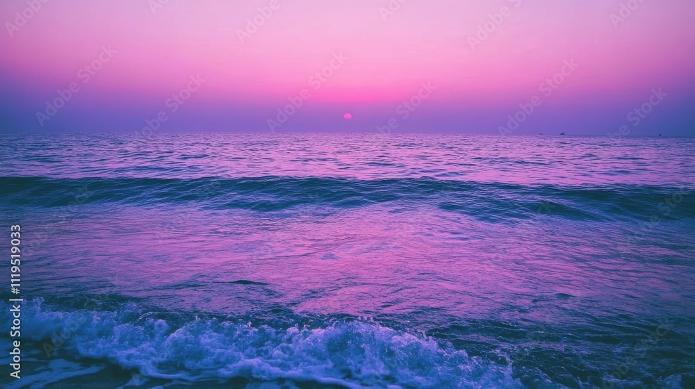Vibrant pink sunset over calm ocean waves at the beach. Vibrant pink sunset over calm ocean waves at the beach.