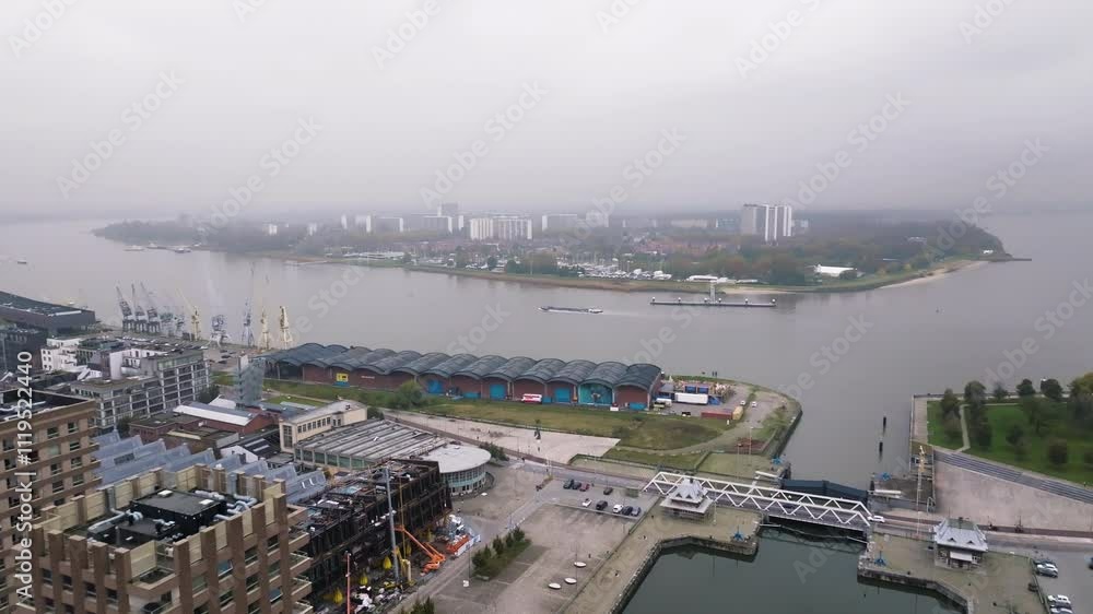 Foggy day over Antwerp harbor, aerial drone fly backward view Foggy day over Antwerp harbor, aerial drone fly backward view