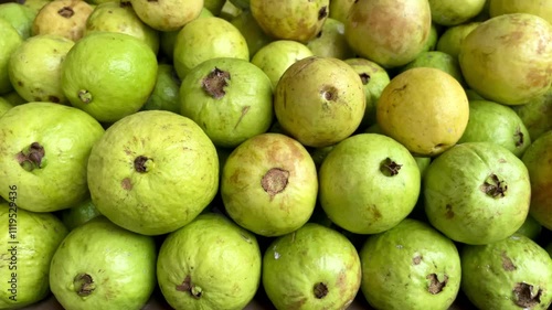 Pile of yellow and light green guava fruit at a fresh fruit vendor. fresh green guava fruit background