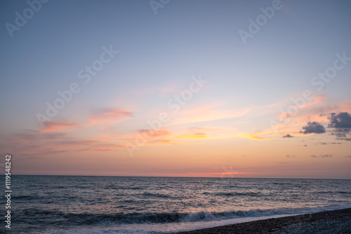 Blue sea and blue sky with white clouds. Seascape.