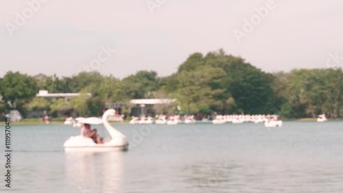 blur of family scene ; On many holidays The family will go to the park to relax. And some families will play duck boats to create family unity and exercise.