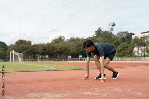 Athlete Preparing for Sprint on Track Symbolizing Determination and Motivation in Sports and Personal Achievement photo