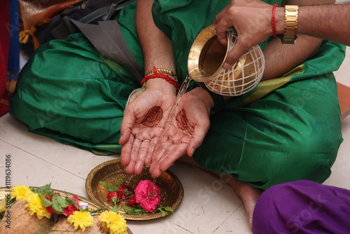 close up of hands performing pooja in indian tradition photo