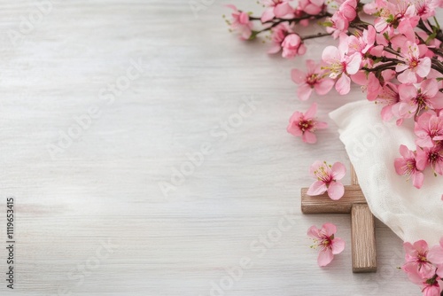 Religious symbol of faith surrounded by delicate flowers on a light wooden background photo