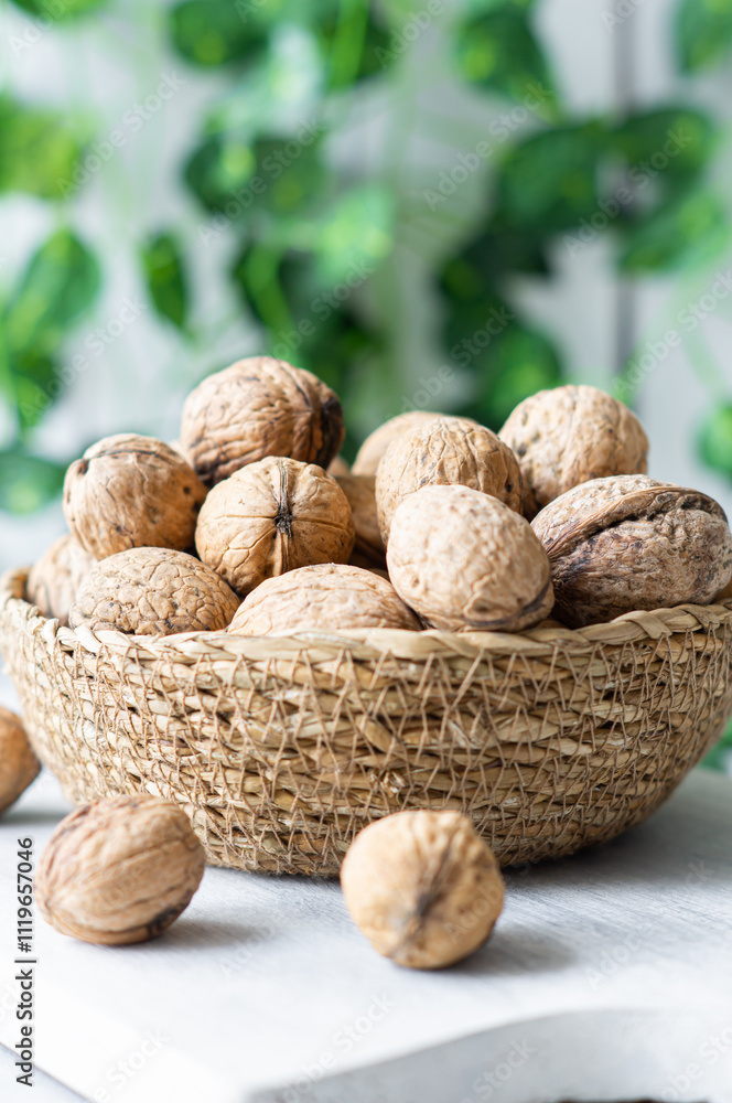 Ripe and raw whole big walnut kernel with Shell in wicker basket on rustic backdrop. healthy nut food for brain Ripe and raw whole big walnut kernel with Shell in wicker basket on rustic backdrop. healthy nut food for brain