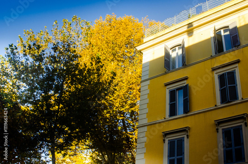 Sunlit Yellow Building and Autumn Trees in Rome