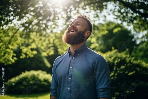 Portrait of a handsome young man with beard in the park.