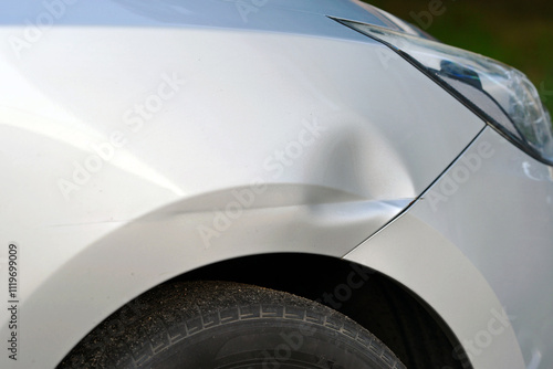 Obraz na płótnie Front fender damage with large dent from an accident, collision repair and auto bodywork challenges. Car with dented front fender from crash impact, vehicle damage need for repair, selective focus w salonie