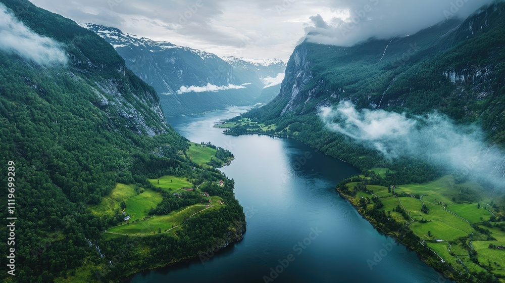 Aerial view of a fjord surrounded by lush green mountains and low clouds. Aerial view of a fjord surrounded by lush green mountains and low clouds.