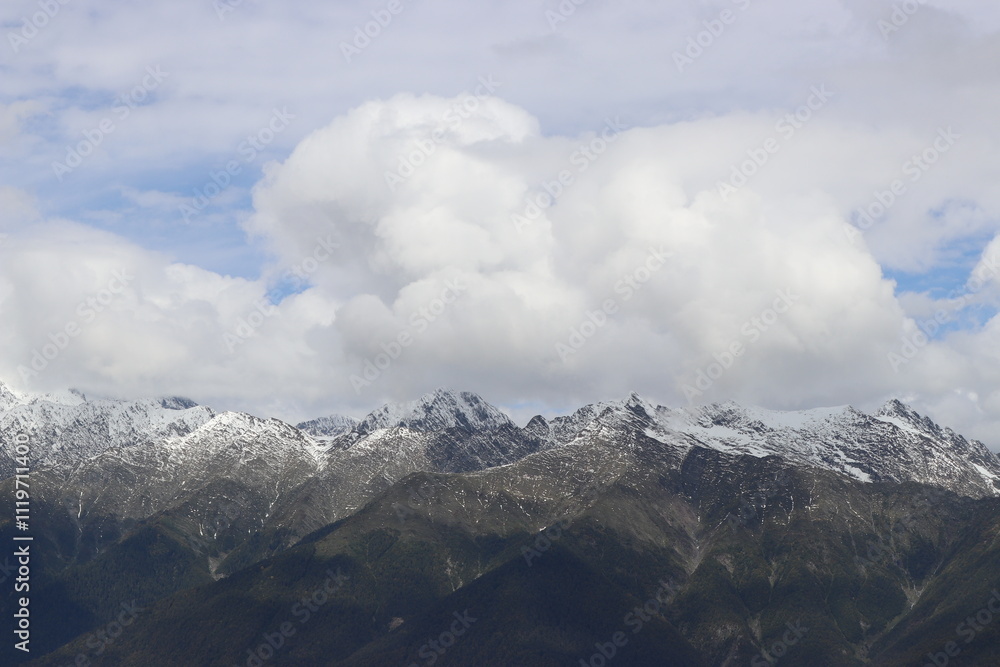 snow-capped mountain peaks in the clouds snow-capped mountain peaks in the clouds